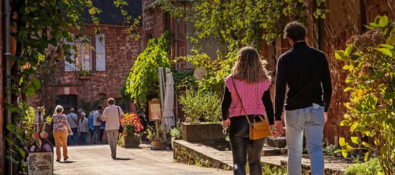 Wandelaars in een smal straatje tussen huizen van natuursteen
